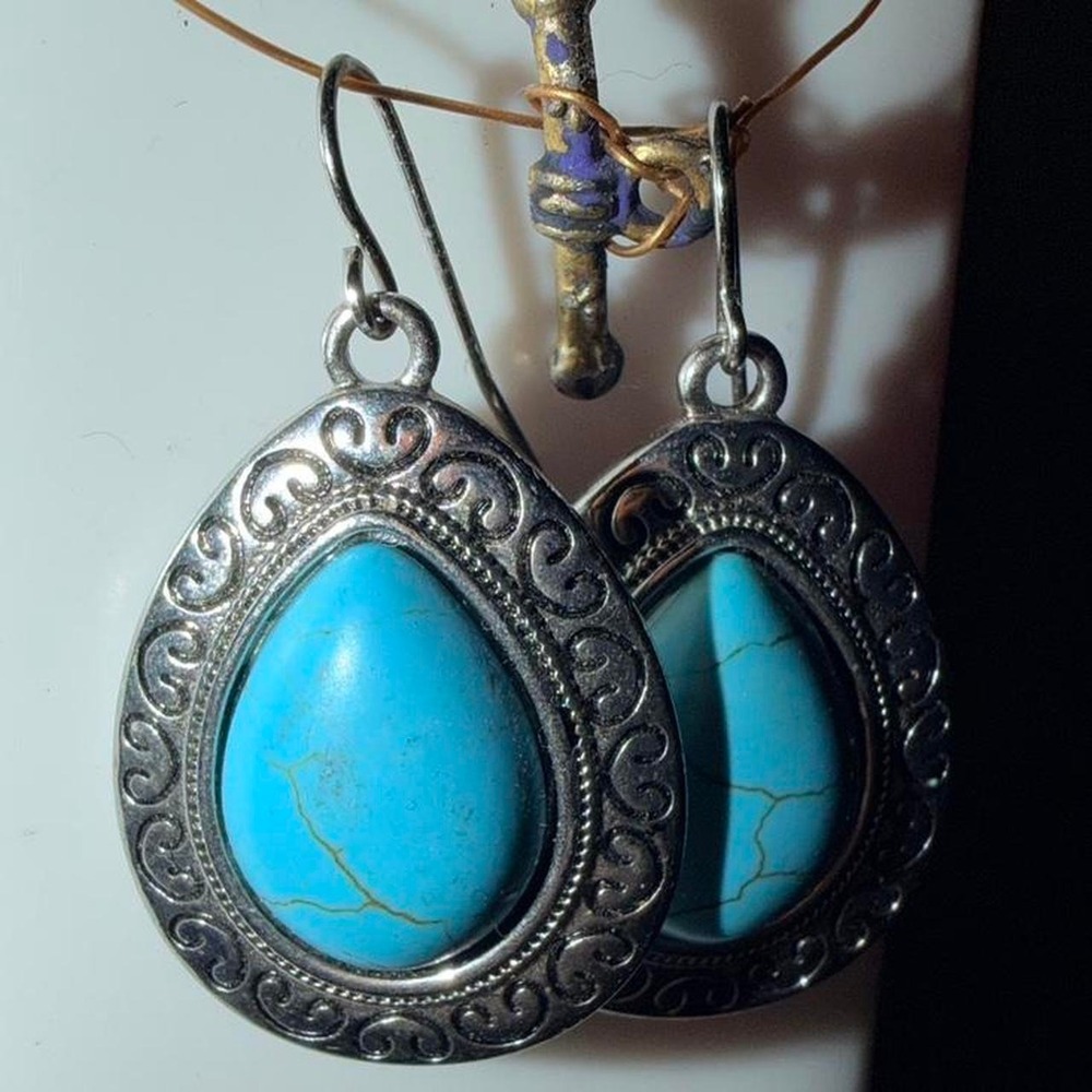 Silver and turquoise earrings with intricate detailing